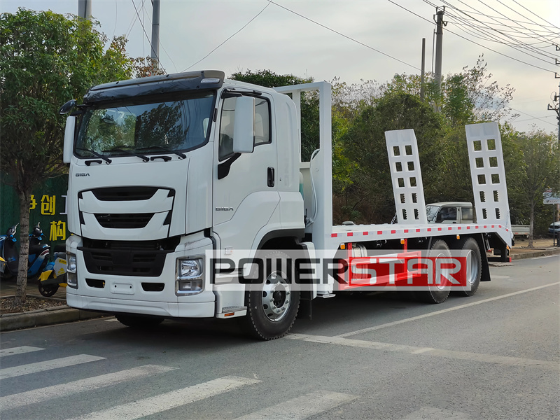 Isuzu Giga 10 wheeler hauling flatbed truck